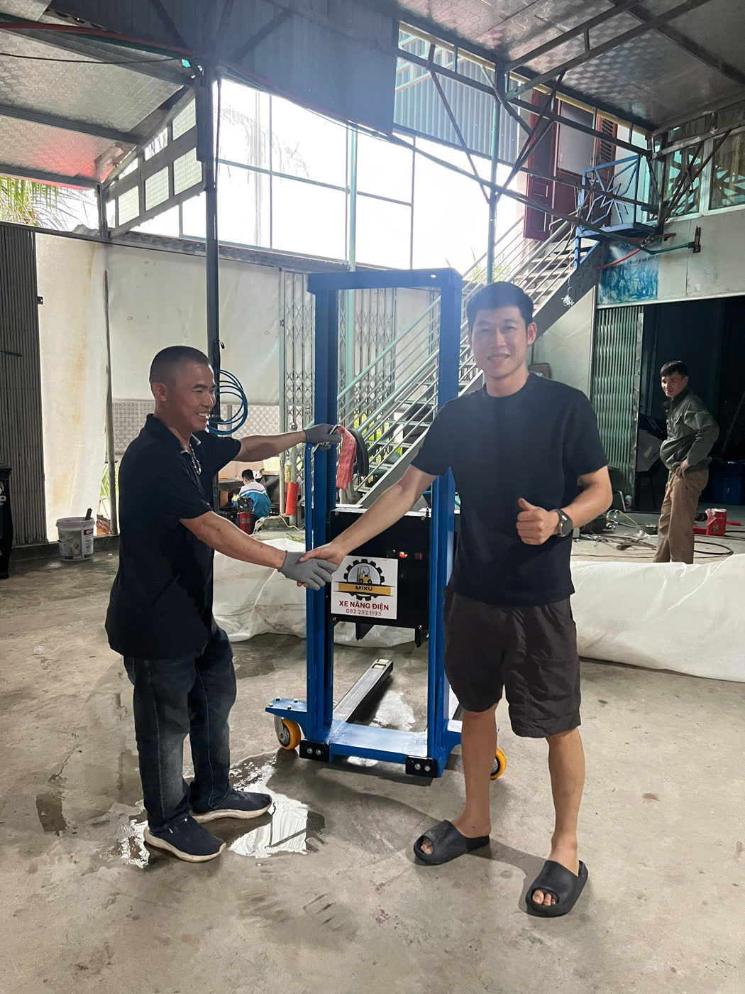 Bàn giao xe nâng MIXU màu xanh tại xưởng của khách